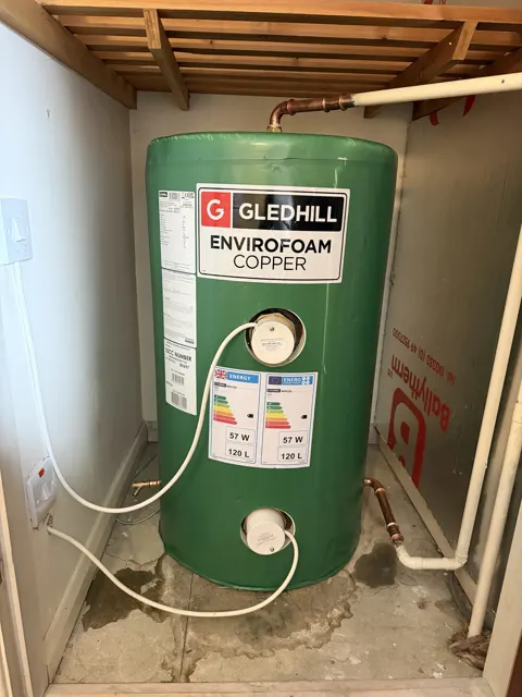 Green Gledhill copper hot water cylinder in a cupboard, before replacement.